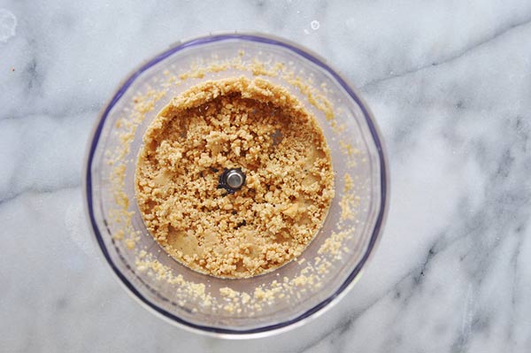 Cashew-Cheese-Crumble in a food processor on a marble surface