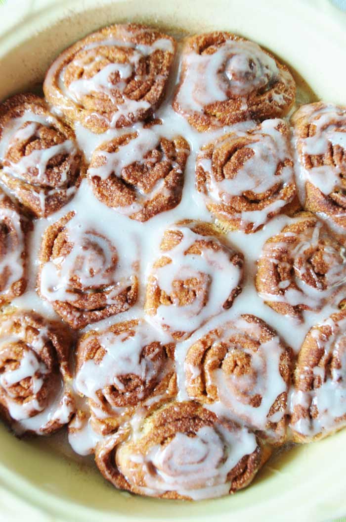 Vegan Cinnamon Rolls in a yellow pan with glaze