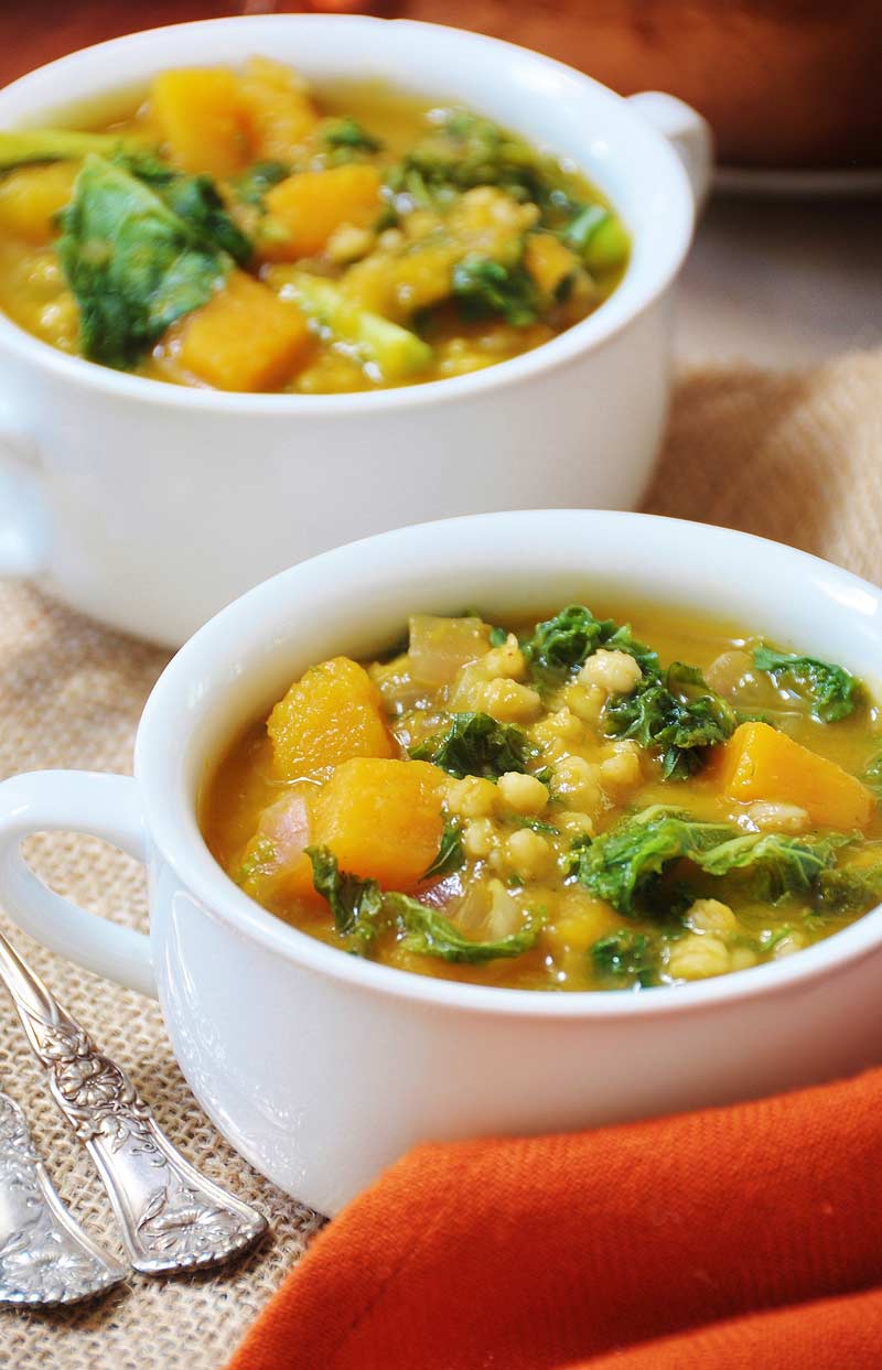 Acorn Squash, Kale, & Barley Soup! This soup recipe is so cozy and flavorful. It's like putting fall in a soup pot. www.veganosity.com