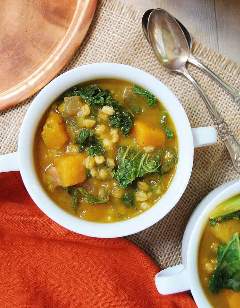 Acorn Squash, Kale, & Barley Soup! This soup recipe is so cozy and flavorful. It's like putting fall in a soup pot. www.veganosity.com