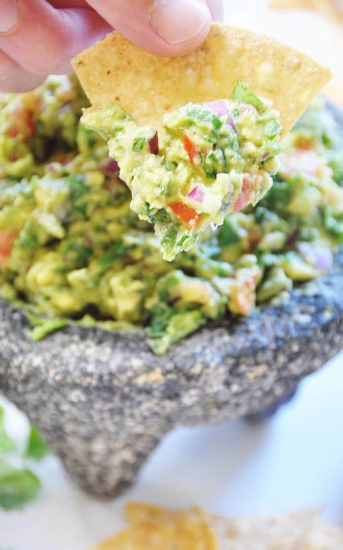 Spinach Guacamole Made in a Molcajete . The molcajete stone bowl makes this spinach guacamole recipe so flavorful and fun to make. The spinach adds protein, iron, and vitamins, and it boosts the volume, and only you will know it's in there. www.veganosity.com