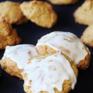 3 vegan pumpkin spice cookies frosted with a sugar glaze.