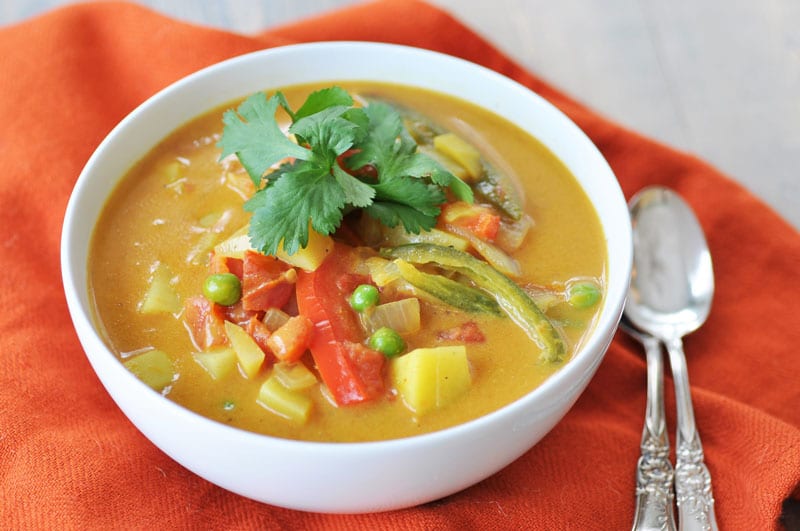 Homemade Yellow Curry Potato Soup! This savory explosion of flavor is exactly what you need for dinner tonight. Potatoes, red bell peppers, serrano peppers, and peas make this a hearty and healthy recipe. One bowl will not be enough. www.veganosity.com