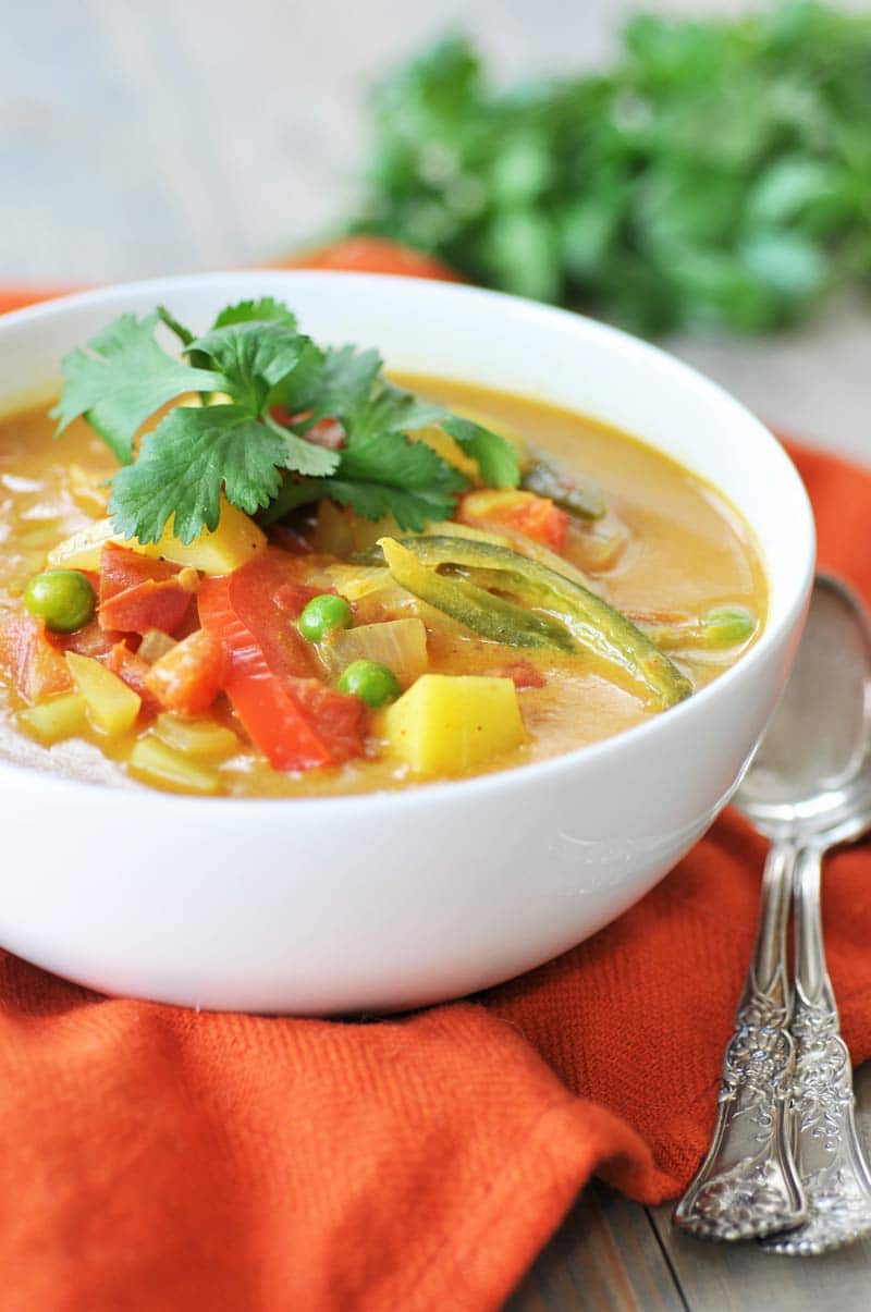 Homemade Yellow Curry Potato Soup! This savory explosion of flavor is exactly what you need for dinner tonight. Potatoes, red bell peppers, serrano peppers, and peas make this a hearty and healthy recipe. One bowl will not be enough. www.veganosity.com