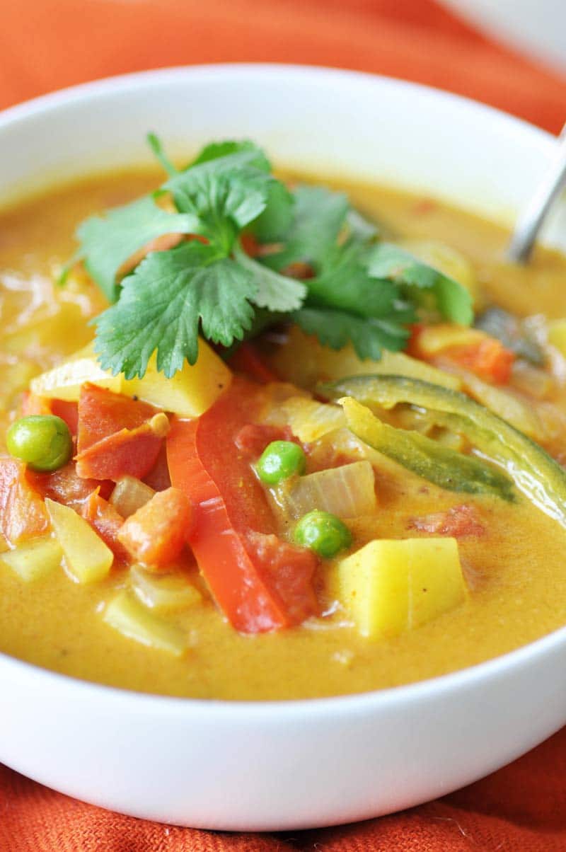 Homemade Yellow Curry Potato Soup! This savory explosion of flavor is exactly what you need for dinner tonight. Potatoes, red bell peppers, serrano peppers, and peas make this a hearty and healthy recipe. One bowl will not be enough. www.veganosity.com