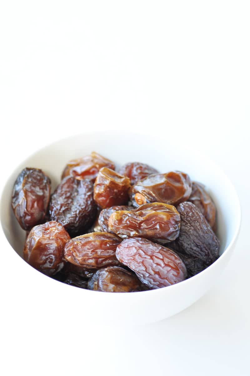 Dried dates in a white bowl