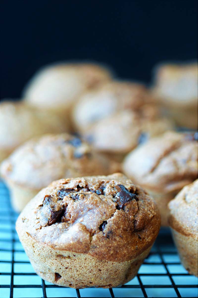 A cooling rack with chocolate muffins cooling on the rack. 