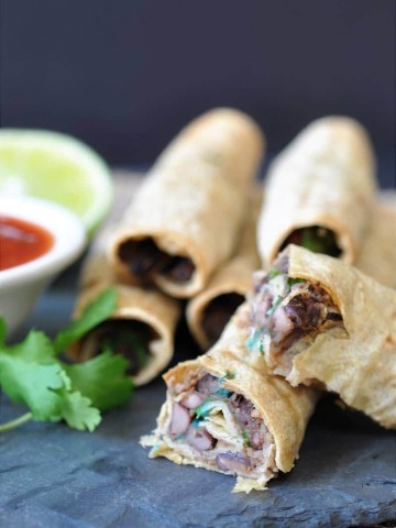 Homemade Black Bean & Spinach Taquitos! This taquito recipe is so crispy on the outside and savory and chewy on the inside. The perfect appetizer or make it part of a meal.
