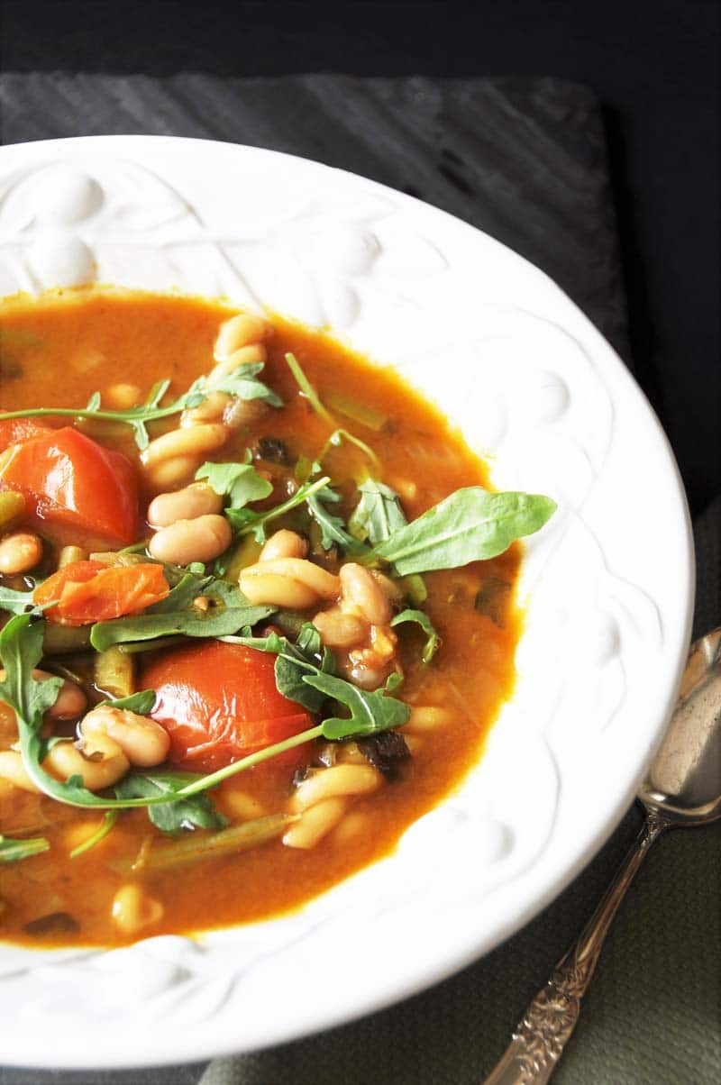 Homemade Minestrone Soup with Arugula! This minestrone soup recipe is so easy to make and so delicious. The peppery arugula adds a fresh and bold statement to an otherwise mild dish. www.veganosity.com