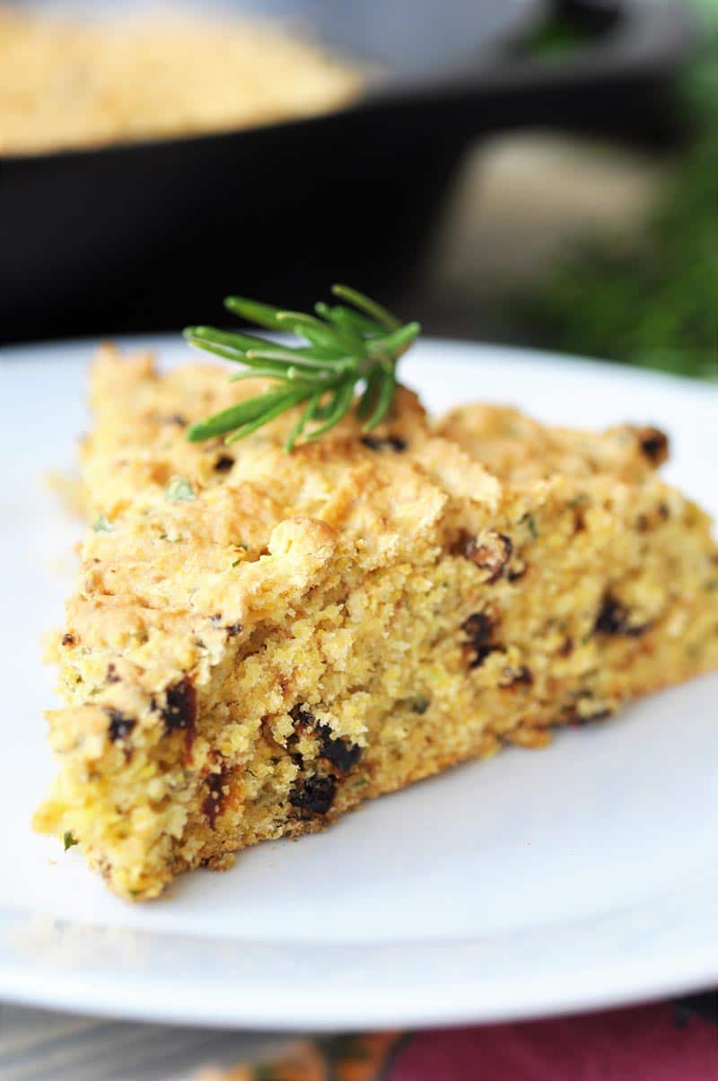 Savory Vegan Italian Cornbread! This flavorful cornbread recipe is filled with sun dried tomatoes and fresh rosemary and basil. This is not your grandma's cornbread. www.veganosity.com