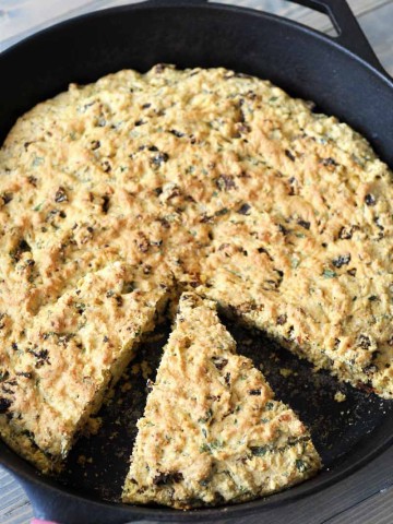 Savory Vegan Italian Cornbread! This flavorful cornbread recipe is filled with sun dried tomatoes and fresh rosemary and basil. This is not your grandma's cornbread. www.veganosity.com