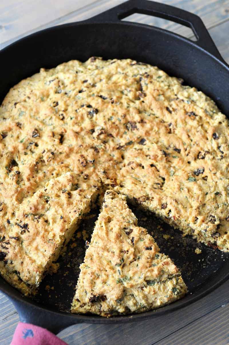 Savory Vegan Italian Cornbread! This flavorful cornbread recipe is filled with sun dried tomatoes and fresh rosemary and basil. This is not your grandma's cornbread. www.veganosity.com