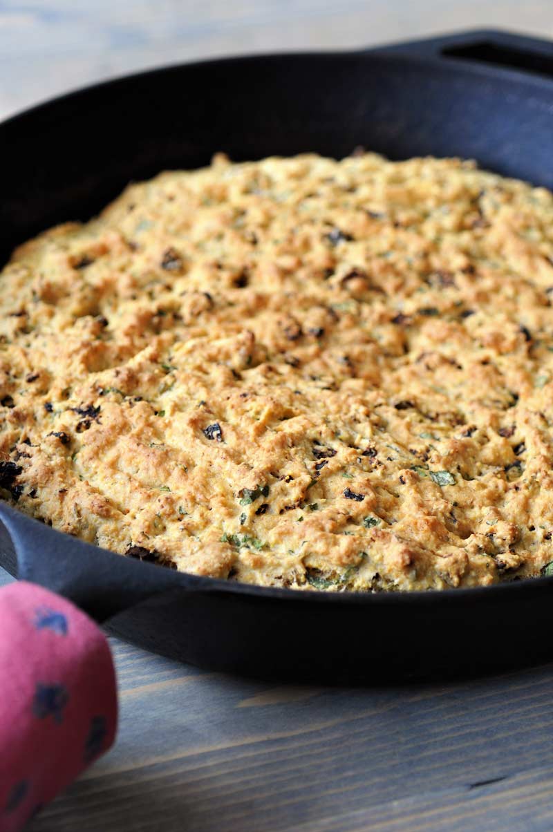 Savory Vegan Italian Cornbread! This flavorful cornbread recipe is filled with sun dried tomatoes and fresh rosemary and basil. This is not your grandma's cornbread. www.veganosity.com