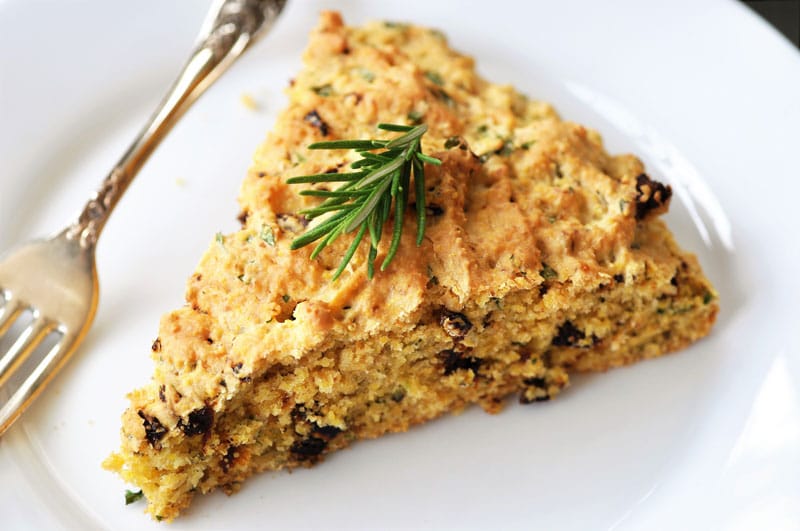Savory Vegan Italian Cornbread! This flavorful cornbread recipe is filled with sun dried tomatoes and fresh rosemary and basil. This is not your grandma's cornbread. www.veganosity.com