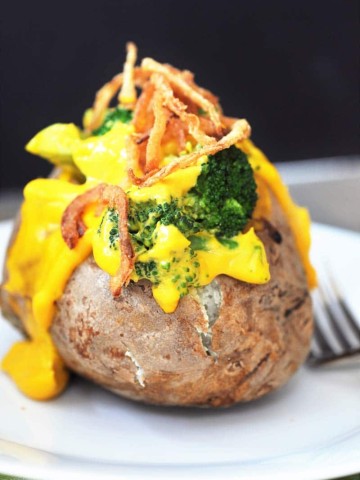 Vegan Cheddar & Broccoli Stuffed Baked Potato! Filled with our 6 Ingredient Vegan Cheddar Cheese Sauce and broccoli. The perfect easy weeknight meal.
