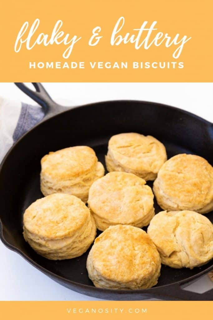 A Pinterest pin for vegan biscuits with a picture of the biscuits in an iron skillet.