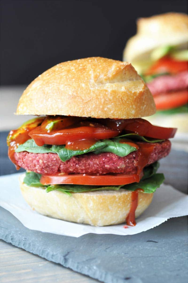 Vegan Beet Burgers that Won't Fall Apart on the Grill! This veggie burger recipe is made with aquafaba. It;s the perfect binder, and it holds the burger together like nothing else does. www.veganosity.com