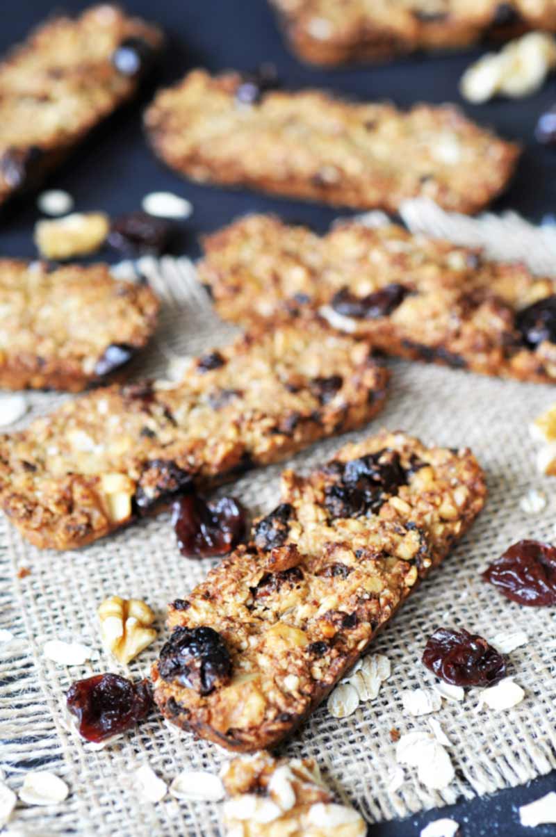 Chewy Cherry-Walnut Oatmeal Energy Bars! This granola bar recipe is filled with tart cherries, walnuts, and oats. Perfect for a post-workout snack or a quick pick me up. www.veganosity.com