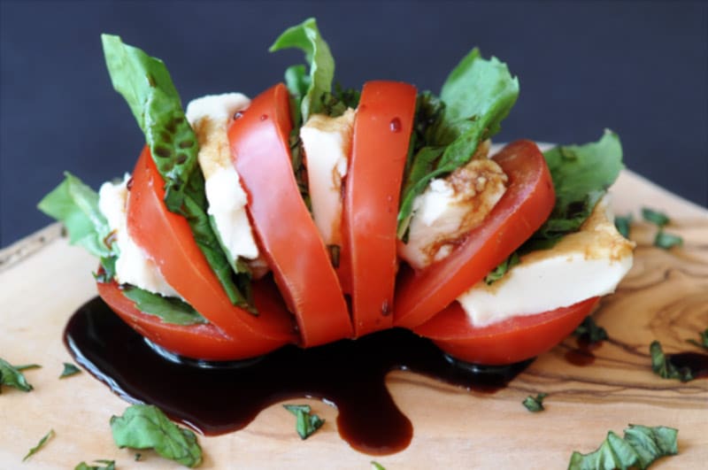 Single Serving Vegan Caprese Salad! This delicious and simple recipe makes the perfect lunch or appetizer for one. All you need is a tomato, some vegan mozzarella, basil, and balsamic vinegar. www.veganosity.com