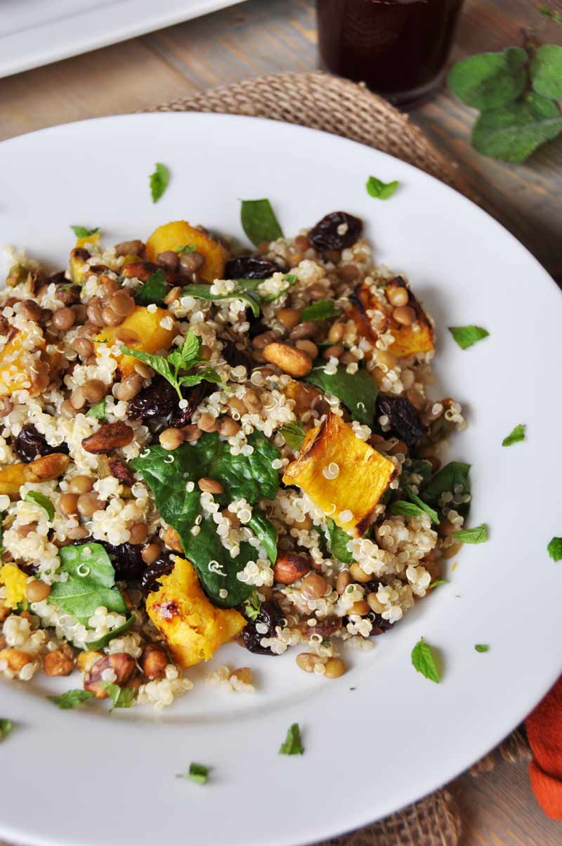 This warm salad with roasted acorn squash, lentils, quinoa, and sage dressing is perfect for fall! www.veganosity.com