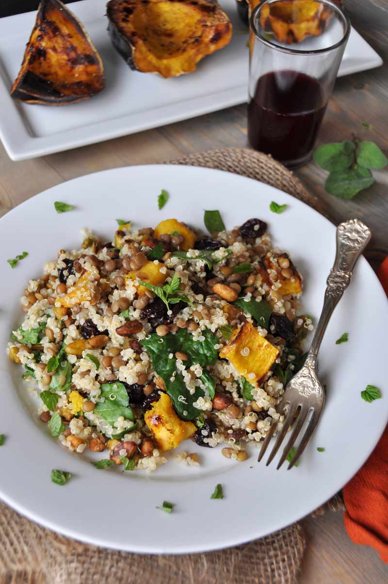 This warm salad with roasted acorn squash, lentils, quinoa, and sage dressing is perfect for fall! www.veganosity.com