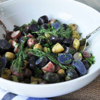 A pretty, festive, and delicious tri-colored potato salad with dill dressing recipe! Perfect for tailgating, holidays, or the election! www.veganosity.com