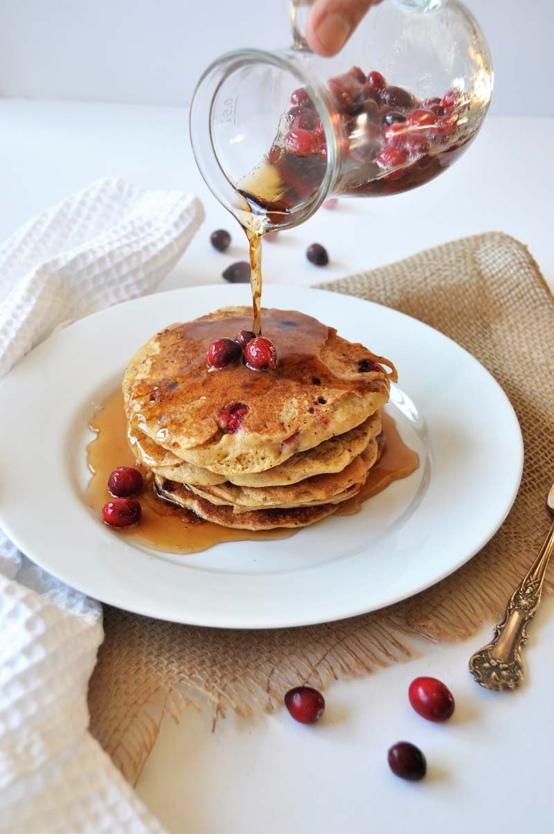 Vegan Cranberry Orange Pancakes for breakfast! Dairy and egg-free recipe, fluffy, and delicious! www.veganosity.com