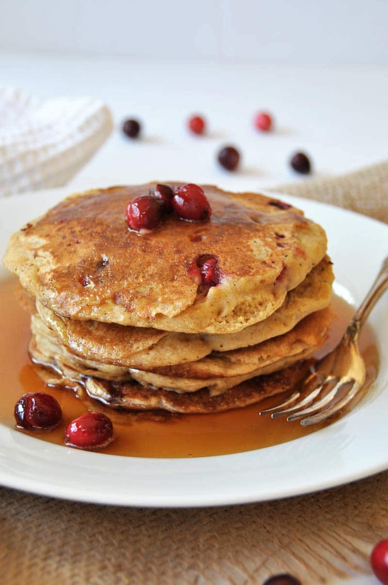 Vegan Cranberry Orange Pancakes for breakfast! Dairy and egg-free recipe, fluffy, and delicious! www.veganosity.com