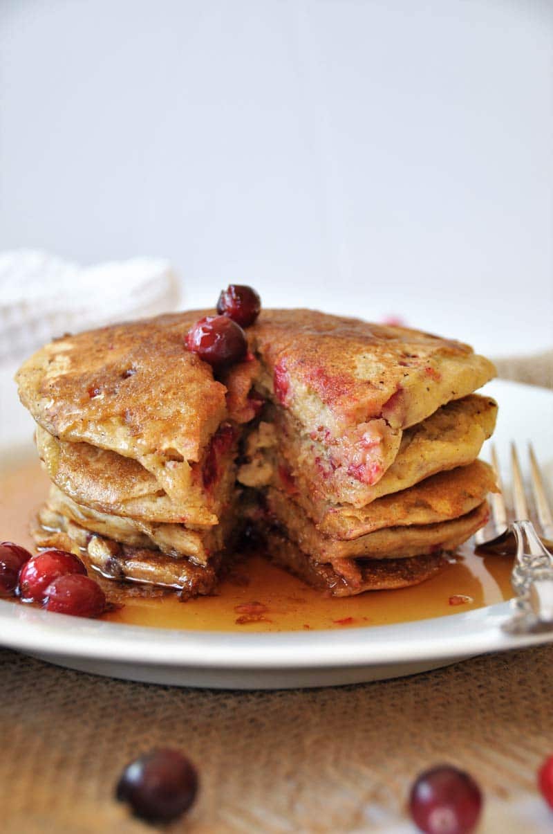 Vegan Cranberry Orange Pancakes for breakfast! Dairy and egg-free recipe, fluffy, and delicious! www.veganosity.com