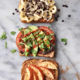 A picture of 3 pieces of toast with sliced apples, sliced avocado and tomato, and the third with banana and chocolate chips.