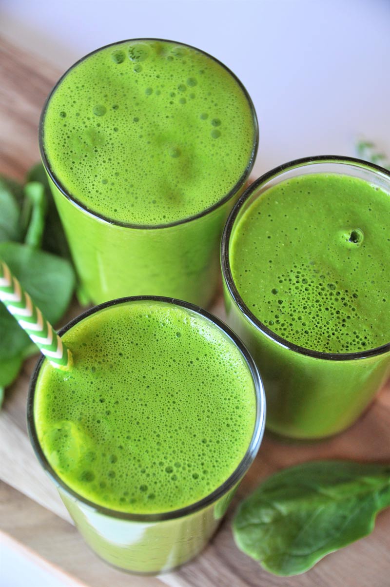 5 ingredient homemade green juice with spinach, apple, lemon, and turmeric. A healthy and tasty way to drink your veggies.