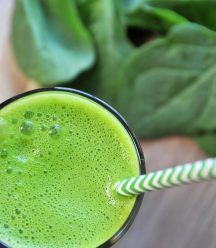 5 ingredient homemade green juice with spinach, apple, lemon, and turmeric. A healthy and tasty way to drink your veggies.