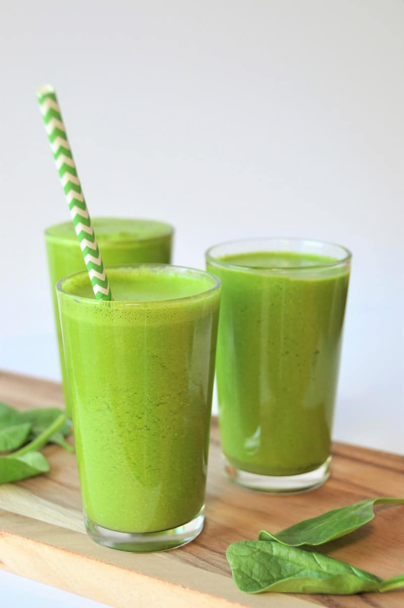 5 ingredient homemade green juice with spinach, apple, lemon, and turmeric. A healthy and tasty way to drink your veggies.