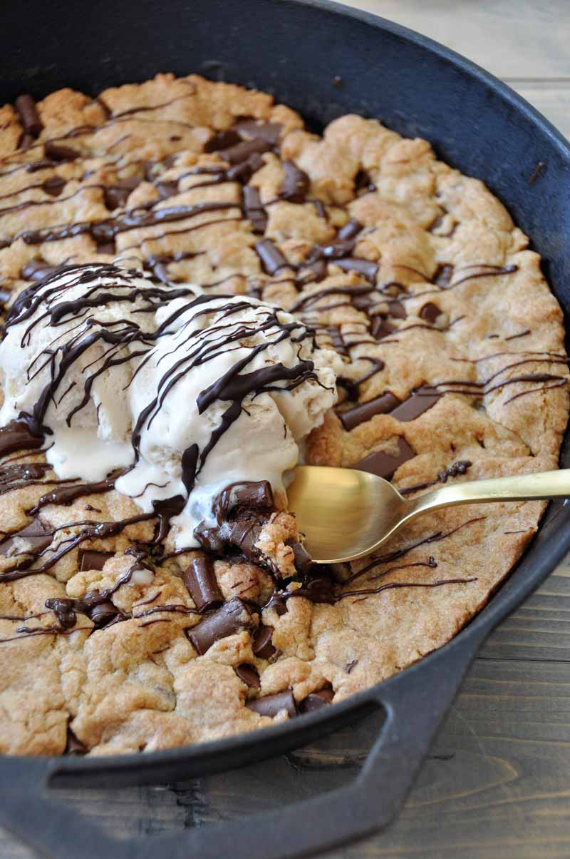 One big vegan chocolate chip cookie in an iron skillet! The perfect dessert for a party. Dairy and egg-free.
