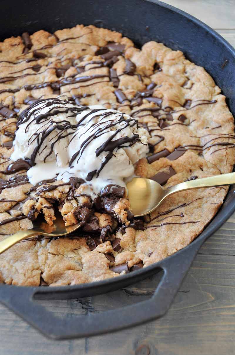 One big vegan chocolate chip cookie in an iron skillet! The perfect dessert for a party. Dairy and egg-free.