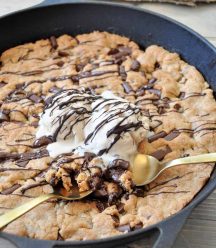 One big vegan chocolate chip cookie in an iron skillet! The perfect dessert for a party. Dairy and egg-free.