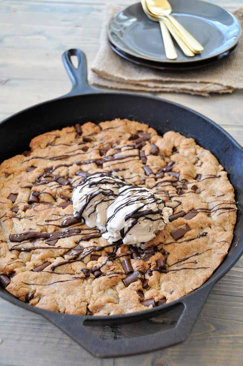 One big vegan chocolate chip cookie in an iron skillet! The perfect dessert for a party. Dairy and egg-free.