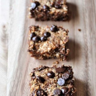 A board with four chocolate chip bars in a line.