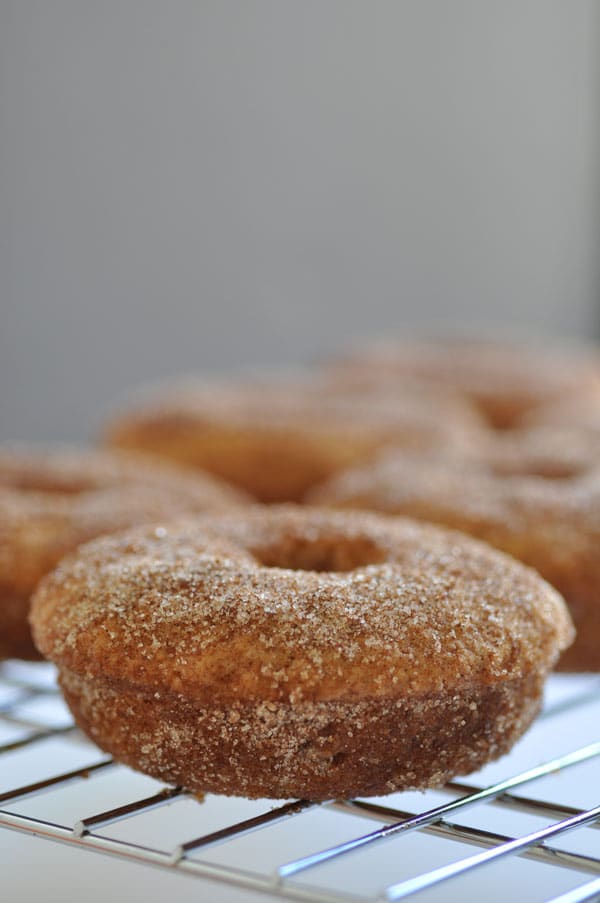 Baked apple cider doughnuts on a wire rack