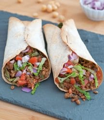 Two vegan Greek Burritos on a slate tray from Vegan Burgers and Burritos cookbook