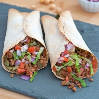 Two vegan Greek Burritos on a slate tray from Vegan Burgers and Burritos cookbook