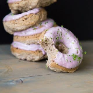 Strawberry Margarita Donuts with lime zest and one donut partially eaten