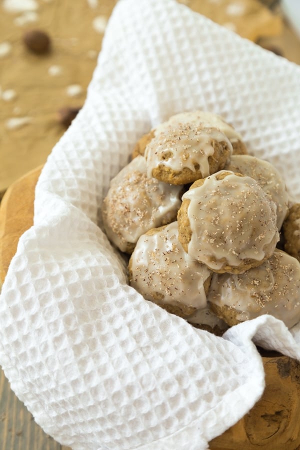 Apple oat cookies frosted in a basket with a white towel