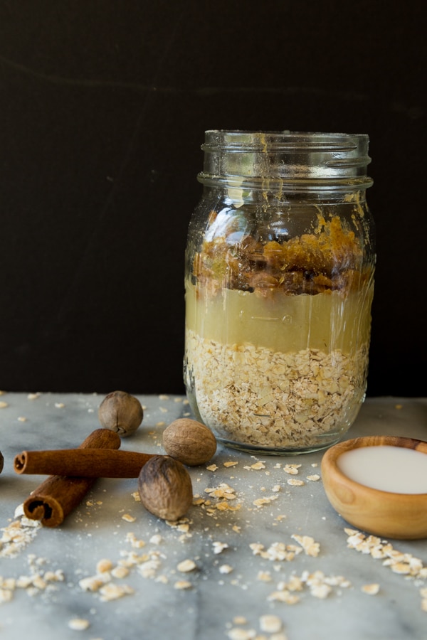 apple overnight oats on a marble board in a mason jar