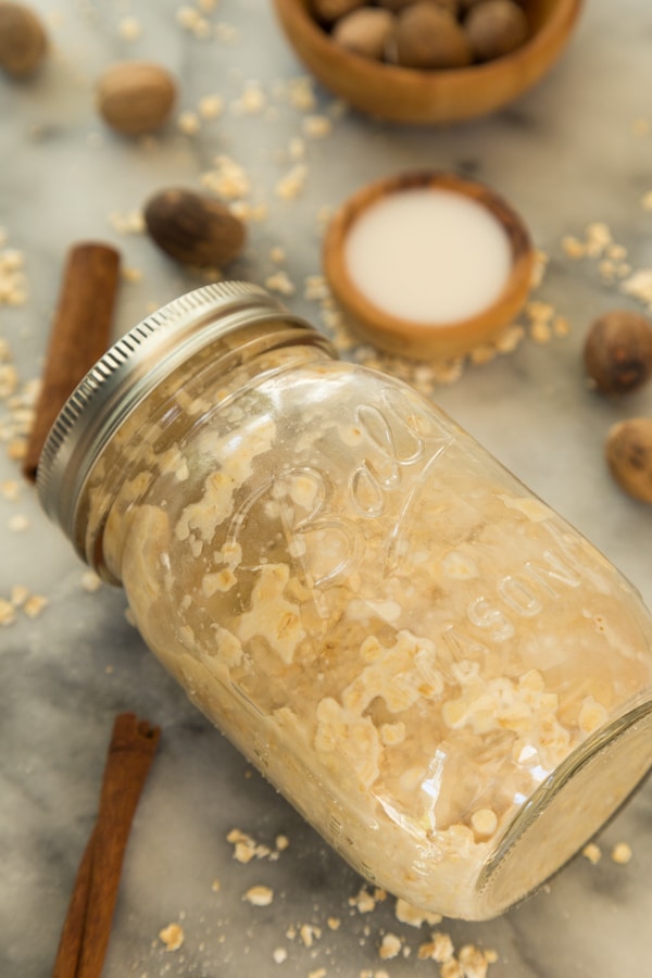prepared apple overnight oats in a mason jar with a marble background 