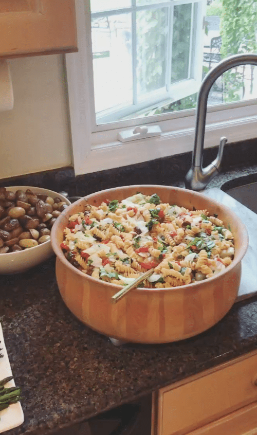 Gluten Free Vegan Tuscan Pasta Salad with assorted veggies in a large wood bowl 