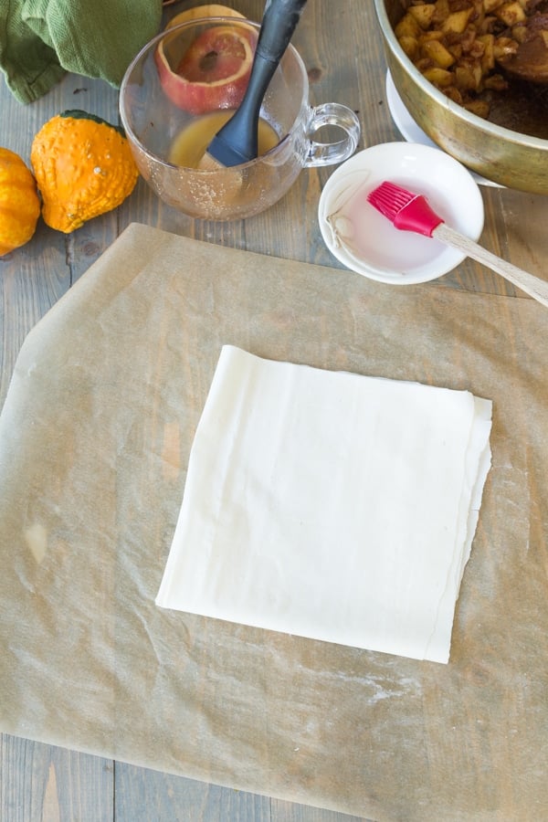 A square of phyllo dough on parchment paper for apple turnovers