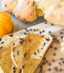 Pumpkin Chocolate Chip braided bread with chocolate chips on a wood board