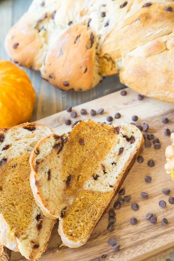 Pumpkin Chocolate Chip braided bread with chocolate chips on a wood board