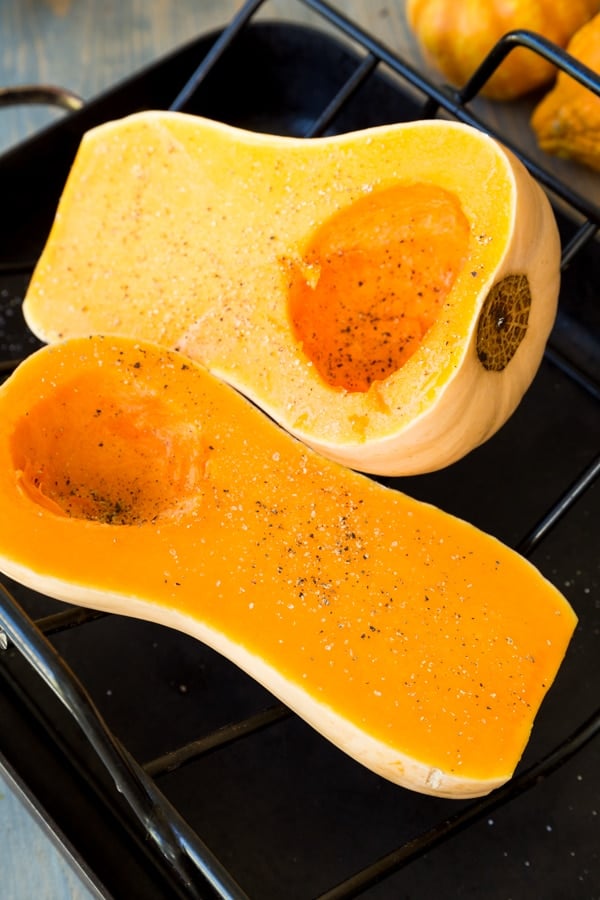 Process shot of butternut squash cut in half with seeds scooped out